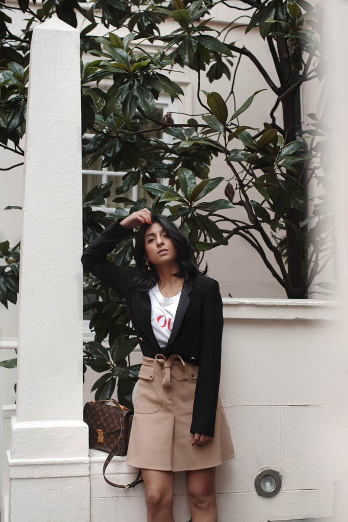 Fashion blogger Shloka Narang of The Silk Sneaker shares her style trick in how to style a blazer for a casual spring outfit idea featuring River Island, Maje, Louis Vuitton and Chanel