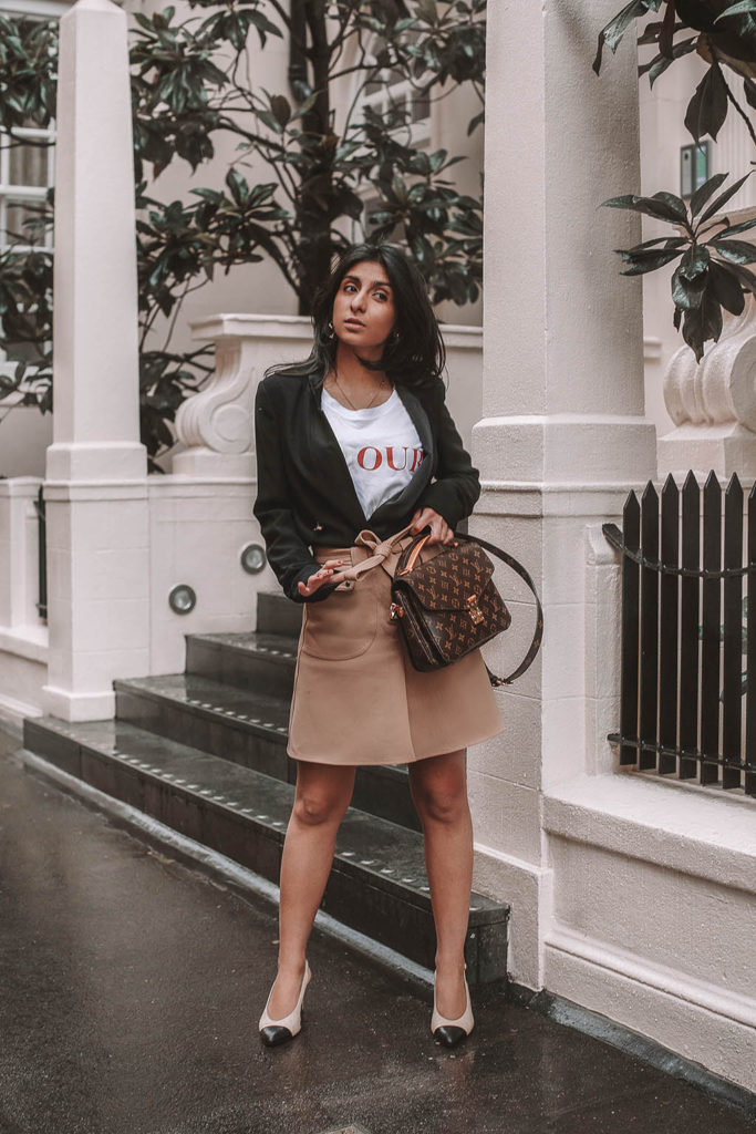 Fashion blogger Shloka Narang of The Silk Sneaker shares her style trick in how to style a blazer for a casual spring outfit idea featuring River Island, Maje, Louis Vuitton and Chanel