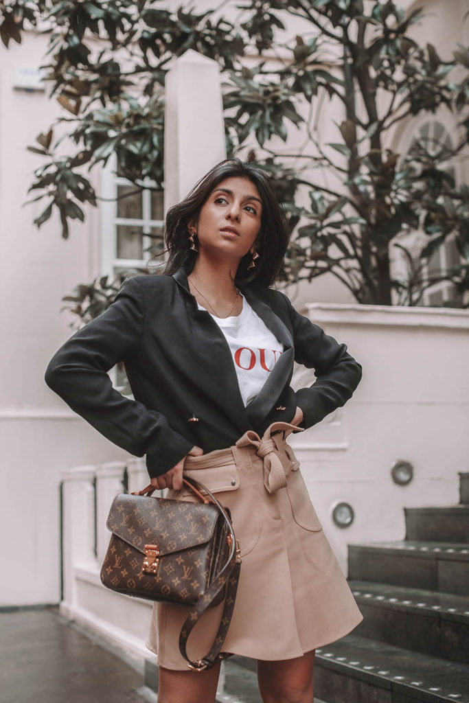 Fashion blogger Shloka Narang of The Silk Sneaker shares her style trick in how to style a blazer for a casual spring outfit idea featuring River Island, Maje, Louis Vuitton and Chanel