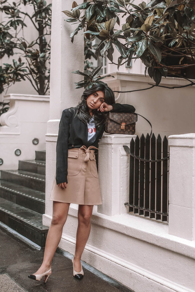 Fashion blogger Shloka Narang of The Silk Sneaker shares her style trick in how to style a blazer for a casual spring outfit idea featuring River Island, Maje, Louis Vuitton and Chanel