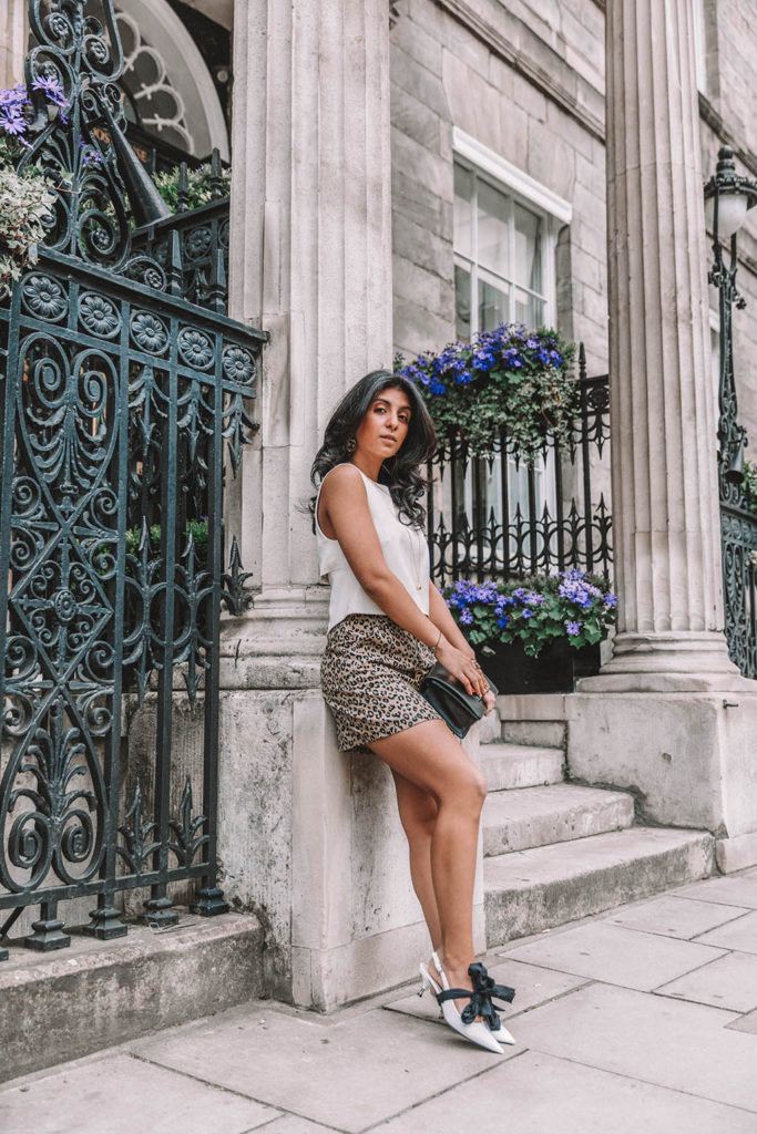 Fashion blogger Shloka Narang of The Silk Sneaker shares why you need a leopard print mini skirt in your wardrobe to create the perfect summer outfit featuring Topshop, Prada and Dior