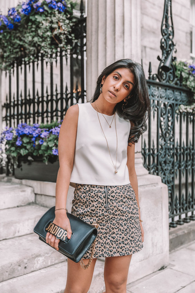 Fashion blogger Shloka Narang of The Silk Sneaker shares why you need a leopard print mini skirt in your wardrobe to create the perfect summer outfit featuring Topshop, Prada and Dior