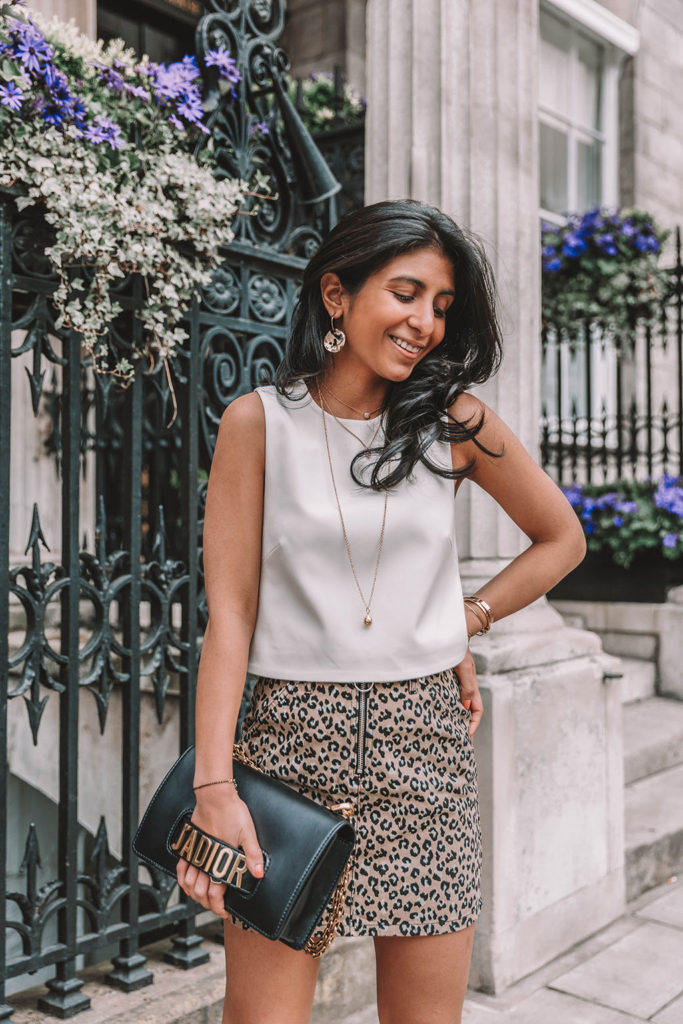 Fashion blogger Shloka Narang of The Silk Sneaker shares why you need a leopard print mini skirt in your wardrobe to create the perfect summer outfit featuring Topshop, Prada and Dior