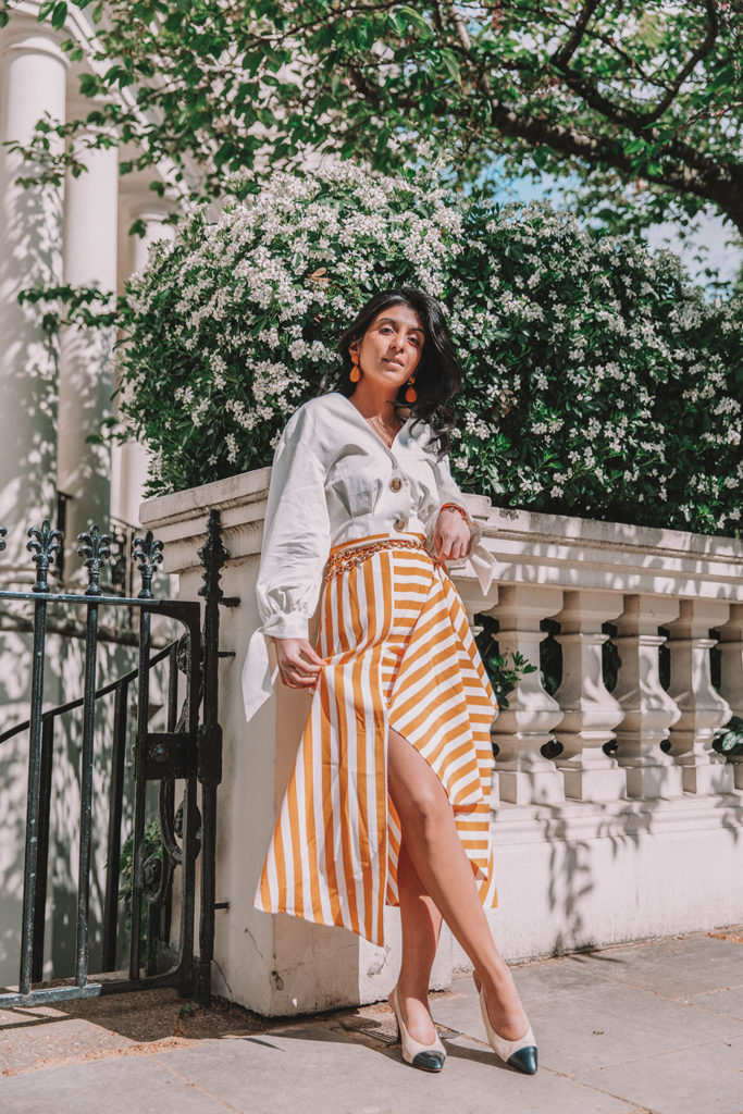 Fashion blogger Shloka Narang of The Silk Sneaker shares how to style the two most popular high street pieces under £100 in one summer outfit including a striped maxi skirt from Topshop and a white Zara top with Chanel vintage slingback heels.