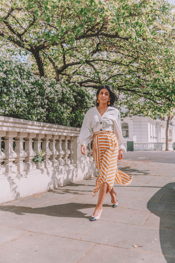 Fashion blogger Shloka Narang of The Silk Sneaker shares how to style the two most popular high street pieces under £100 in one summer outfit including a striped maxi skirt from Topshop and a white Zara top with Chanel vintage slingback heels.
