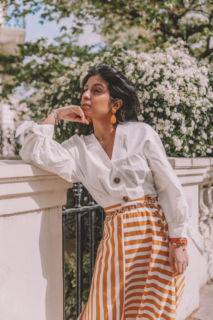 Fashion blogger Shloka Narang of The Silk Sneaker shares how to style the two most popular high street pieces under £100 in one summer outfit including a striped maxi skirt from Topshop and a white Zara top with Chanel vintage slingback heels.