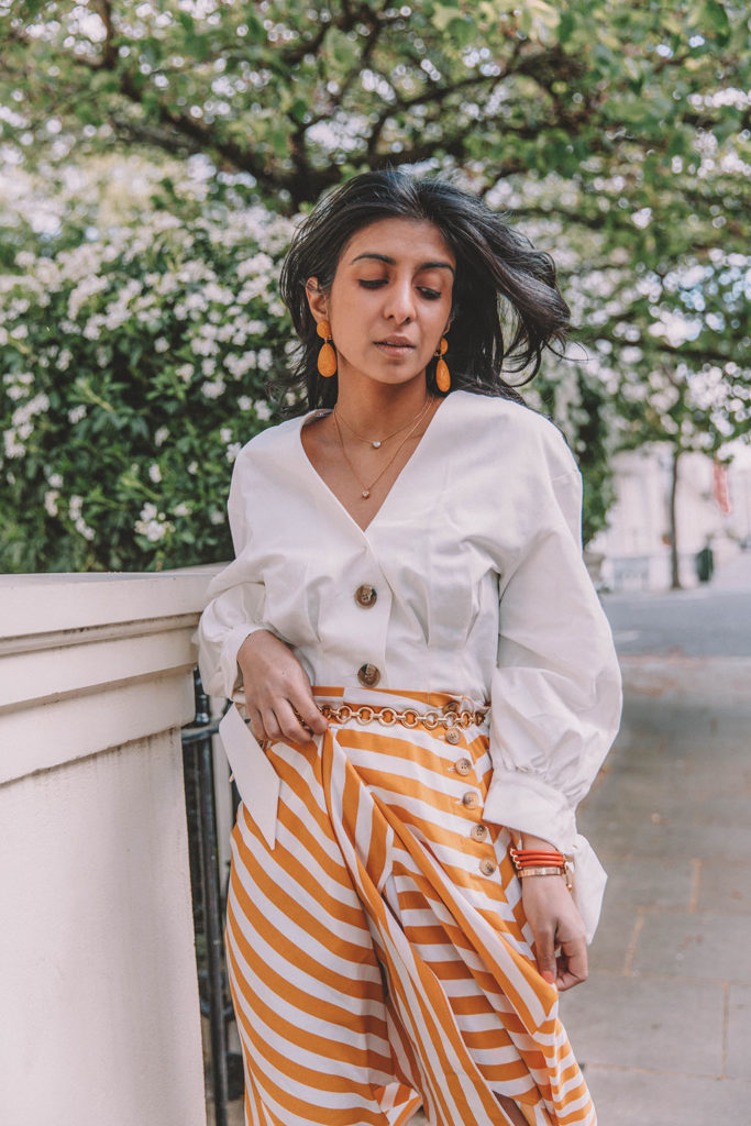 Fashion blogger Shloka Narang of The Silk Sneaker shares how to style the two most popular high street pieces under £100 in one summer outfit including a striped maxi skirt from Topshop and a white Zara top with Chanel vintage slingback heels.