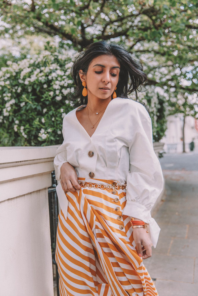 Fashion blogger Shloka Narang of The Silk Sneaker shares how to style the two most popular high street pieces under £100 in one summer outfit including a striped maxi skirt from Topshop and a white Zara top with Chanel vintage slingback heels.