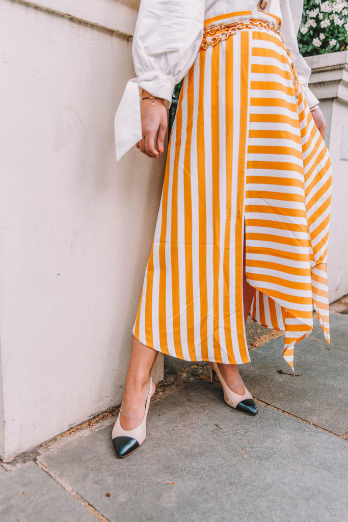 Fashion blogger Shloka Narang of The Silk Sneaker shares how to style the two most popular high street pieces under £100 in one summer outfit including a striped maxi skirt from Topshop and a white Zara top with Chanel vintage slingback heels.