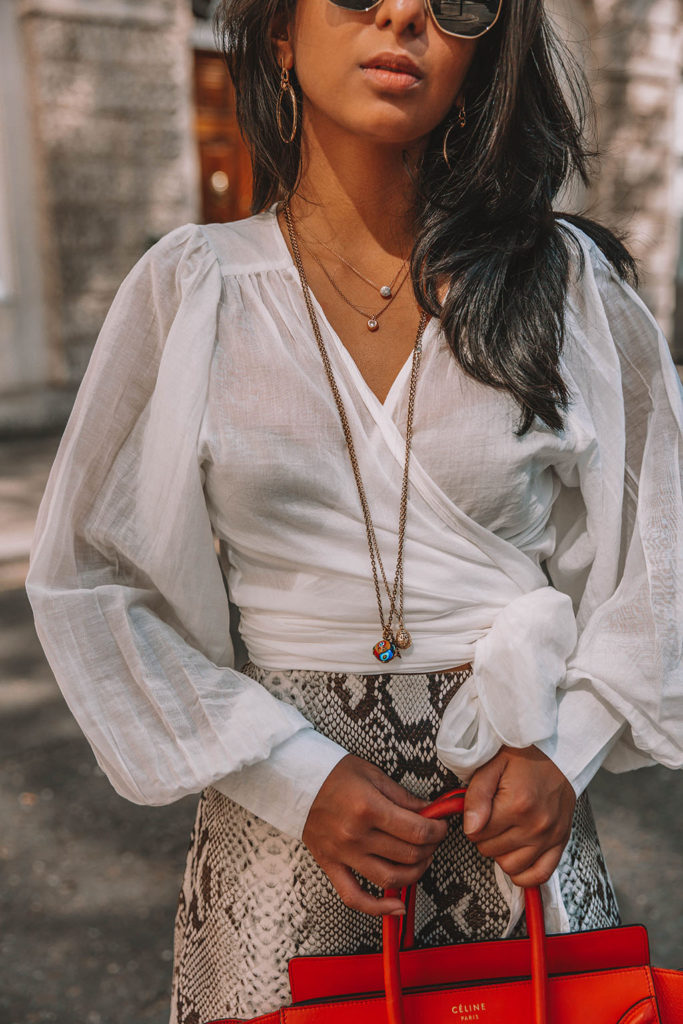Fashion blogger Shloka Narang of The Silk Sneaker shares the summer blouse you need to create a cute summer outfit featuring ba&sh, Celine and Ray-Ban