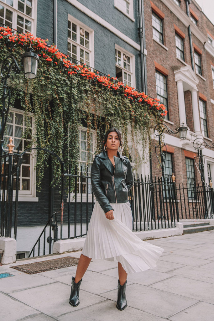 Luxury fashion blogger Shloka Narang of The Silk Sneaker shares how to style a summer pleated maxi skirt for autumn featuring Maje and Isabel Marant in a summer to fall transitional outfit