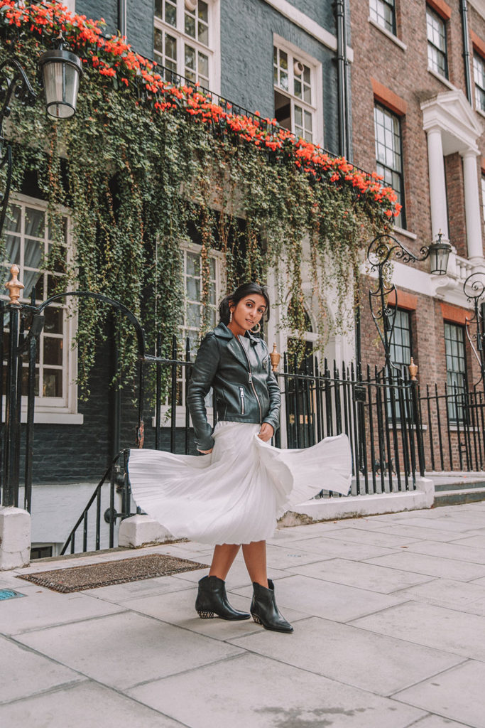 Luxury fashion blogger Shloka Narang of The Silk Sneaker shares how to style a summer pleated maxi skirt for autumn featuring Maje and Isabel Marant in a summer to fall transitional outfit