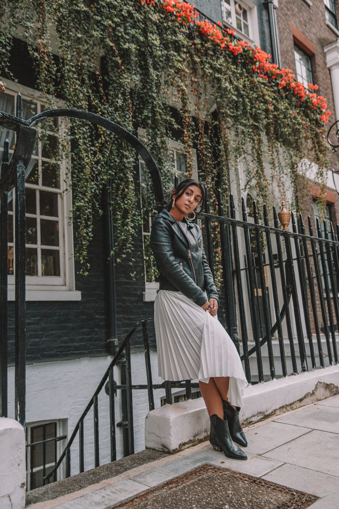 Luxury fashion blogger Shloka Narang of The Silk Sneaker shares how to style a summer pleated maxi skirt for autumn featuring Maje and Isabel Marant in a summer to fall transitional outfit