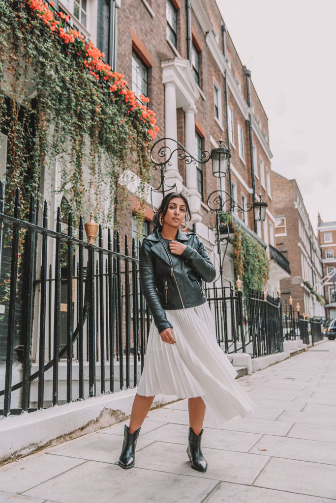Luxury fashion blogger Shloka Narang of The Silk Sneaker shares how to style a summer pleated maxi skirt for autumn featuring Maje and Isabel Marant in a summer to fall transitional outfit