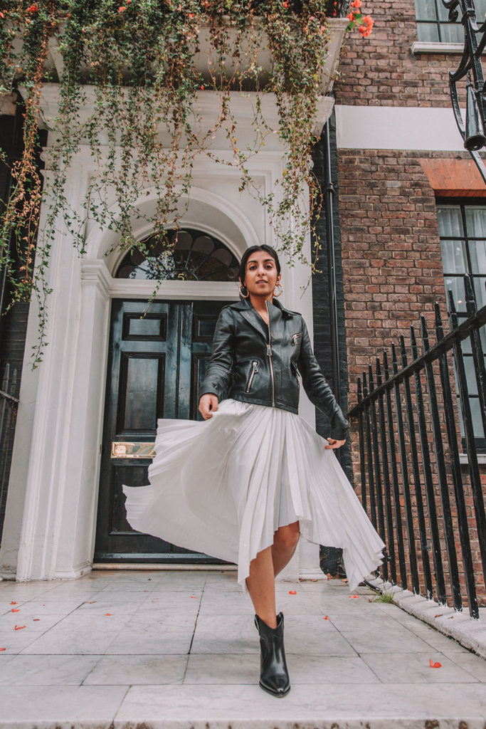 Luxury fashion blogger Shloka Narang of The Silk Sneaker shares how to style a summer pleated maxi skirt for autumn featuring Maje and Isabel Marant in a summer to fall transitional outfit