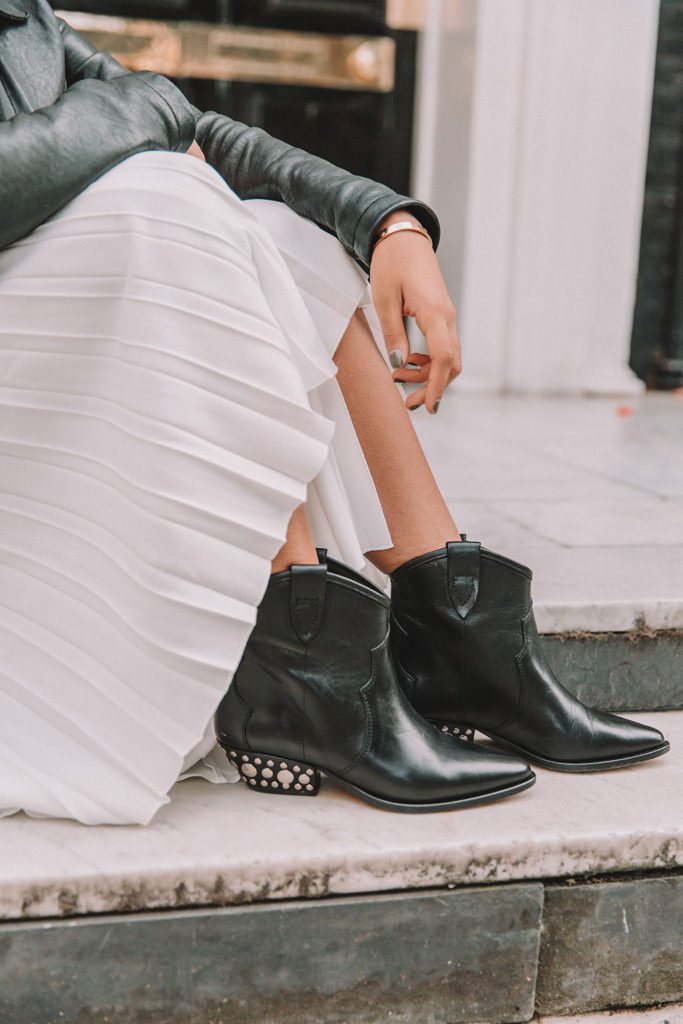 Luxury fashion blogger Shloka Narang of The Silk Sneaker shares how to style a summer pleated maxi skirt for autumn featuring Maje and Isabel Marant in a summer to fall transitional outfit