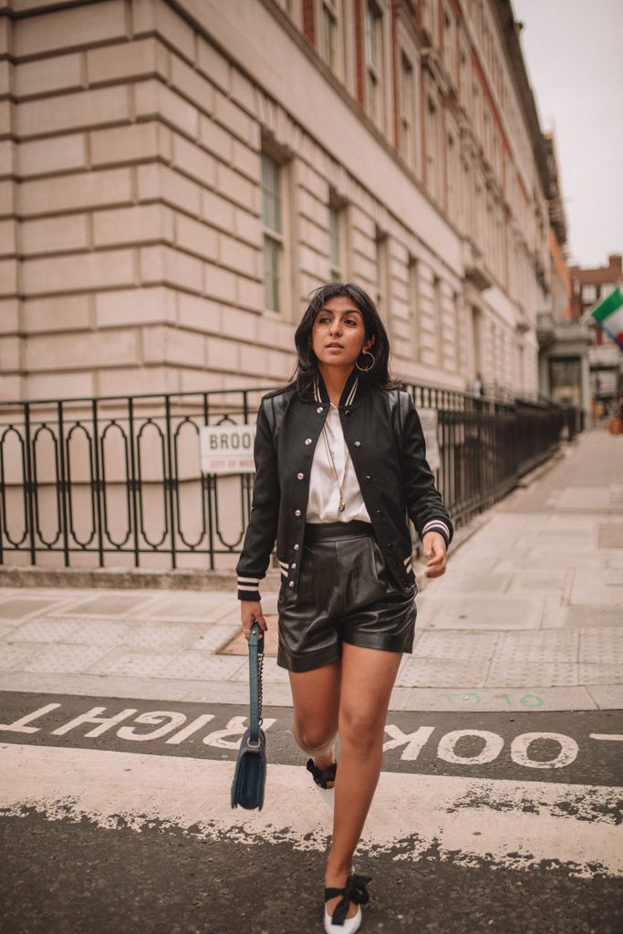 Luxury fashion blogger Shloka Narang of The Silk Sneaker shares how to style a trending piece for autumn winter 2018, leather shorts, featuring Chanel, Saint Laurent and Mango