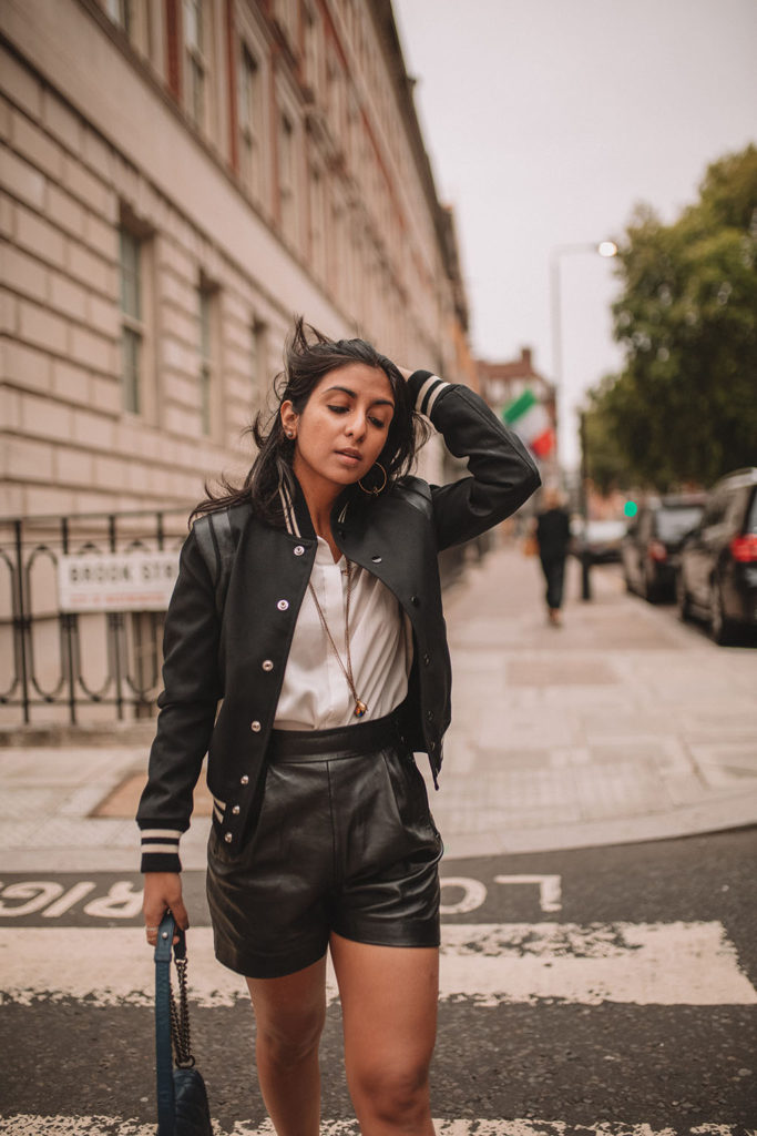 Luxury fashion blogger Shloka Narang of The Silk Sneaker shares how to style a trending piece for autumn winter 2018, leather shorts, featuring Chanel, Saint Laurent and Mango