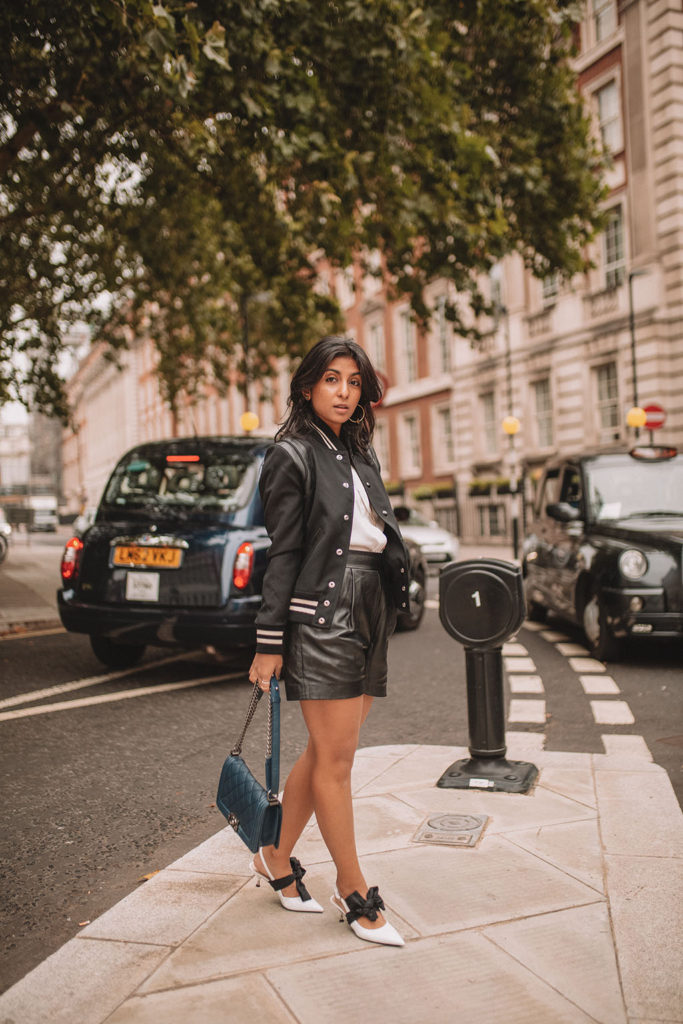Luxury fashion blogger Shloka Narang of The Silk Sneaker shares how to style a trending piece for autumn winter 2018, leather shorts, featuring Chanel, Saint Laurent and Mango