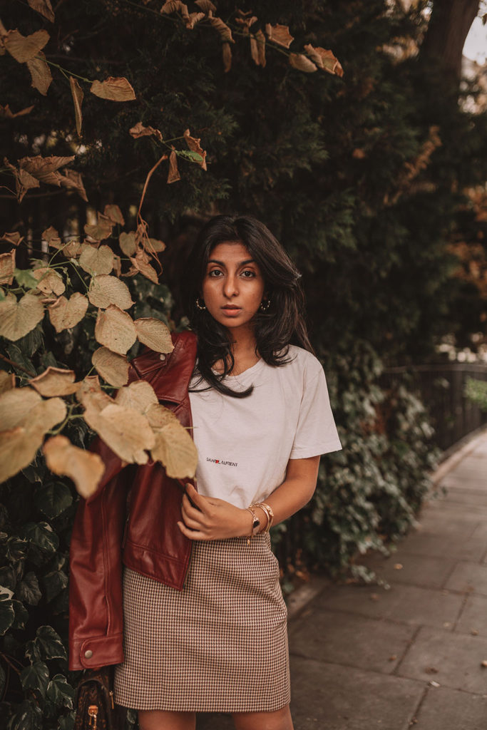 Luxury fashion blogger Shloka Narang of The Silk Sneaker shares how to wear a slogan tee in the autumn featuring Saint Laurent, & Other Stories and Louis Vuitton