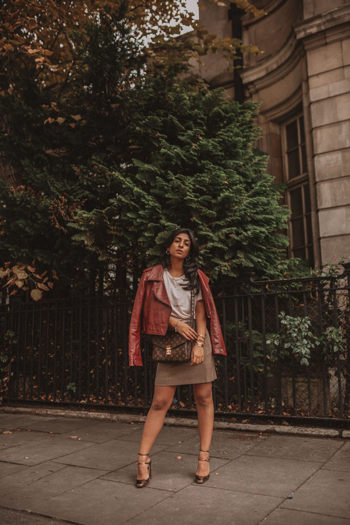 Luxury fashion blogger Shloka Narang of The Silk Sneaker shares how to wear a slogan tee in the autumn featuring Saint Laurent, & Other Stories and Louis Vuitton