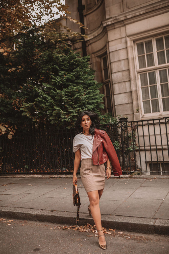 Luxury fashion blogger Shloka Narang of The Silk Sneaker shares how to wear a slogan tee in the autumn featuring Saint Laurent, & Other Stories and Louis Vuitton