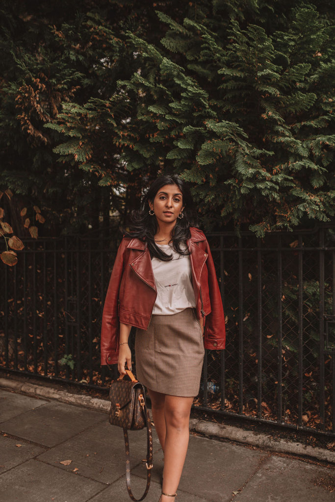 Luxury fashion blogger Shloka Narang of The Silk Sneaker shares how to wear a slogan tee in the autumn featuring Saint Laurent, & Other Stories and Louis Vuitton