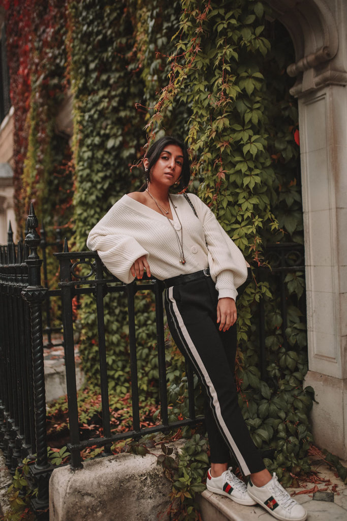 Luxury fashion blogger Shoka Narang of The Silk Sneaker shares how to style an oversized knit cardigan for a cute winter outfit with & Other Stories, Chanel backpack and Gucci Sneakers