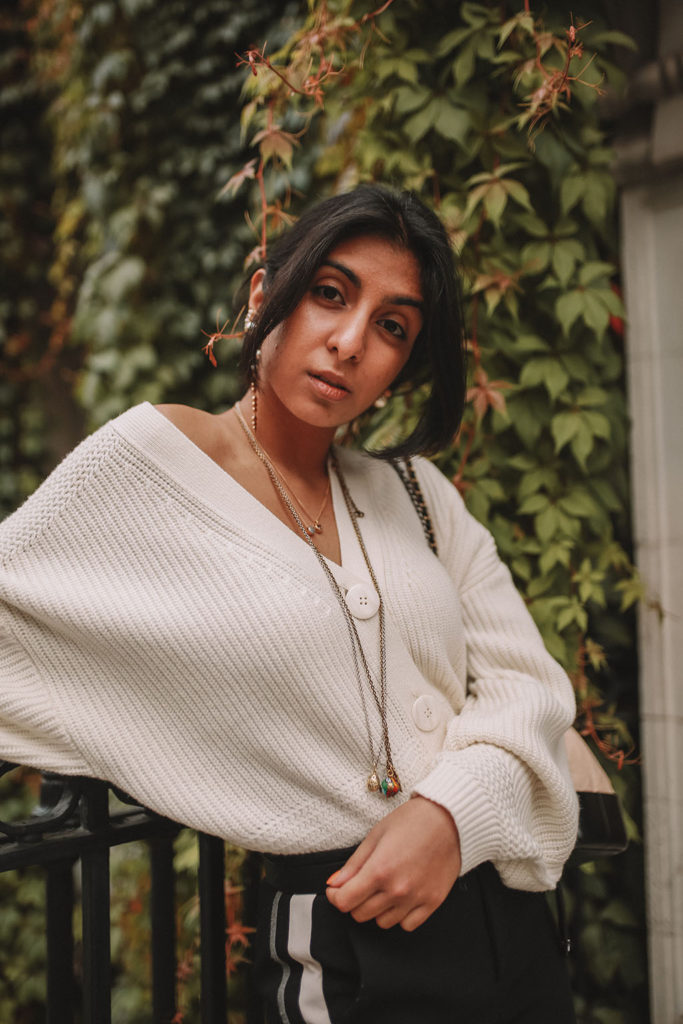 Luxury fashion blogger Shoka Narang of The Silk Sneaker shares how to style an oversized knit cardigan for a cute winter outfit with & Other Stories, Chanel backpack and Gucci Sneakers