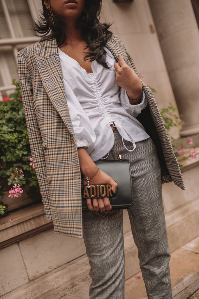 Luxury fashion blogger Shloka Narang of The Silk Sneaker shows how to style a plaid blazer and plaid pants for a casual chic fall outfit