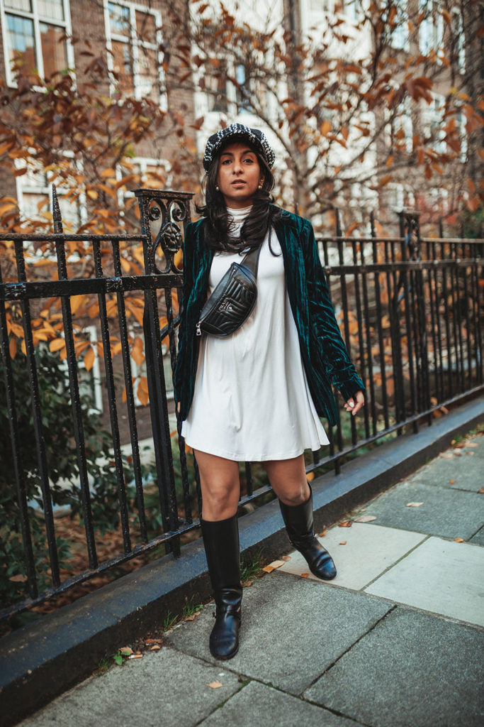 Luxury fashion blogger Shloka Narang of The Silk Sneaker shares how to wear a belt bag with a Prada belt bag, ASOS dress and velvet blazer for a winter outfit