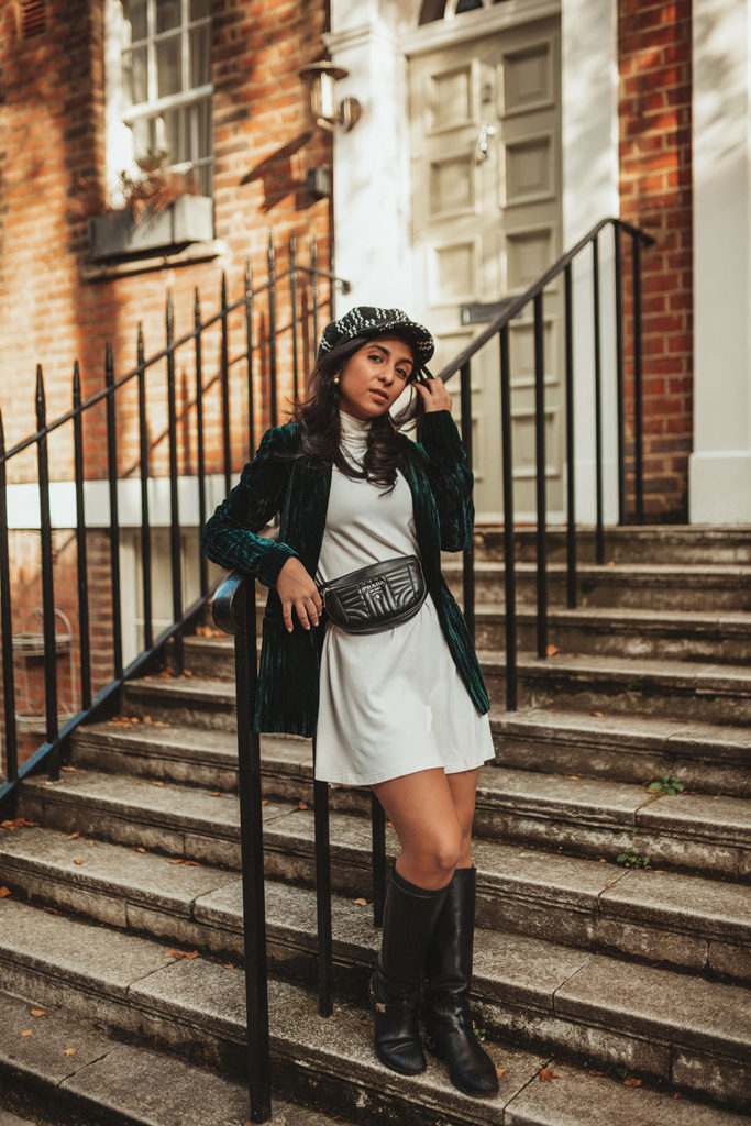 Luxury fashion blogger Shloka Narang of The Silk Sneaker shares how to wear a belt bag with a Prada belt bag, ASOS dress and velvet blazer for a winter outfit