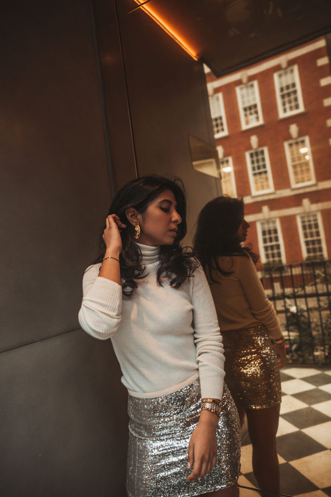 Luxury fashion blogger Shloka Narang of The Silk Sneaker shares a holiday party outfit idea featuring a sequins skirt from Topshop and Gianvitto Rossi heels