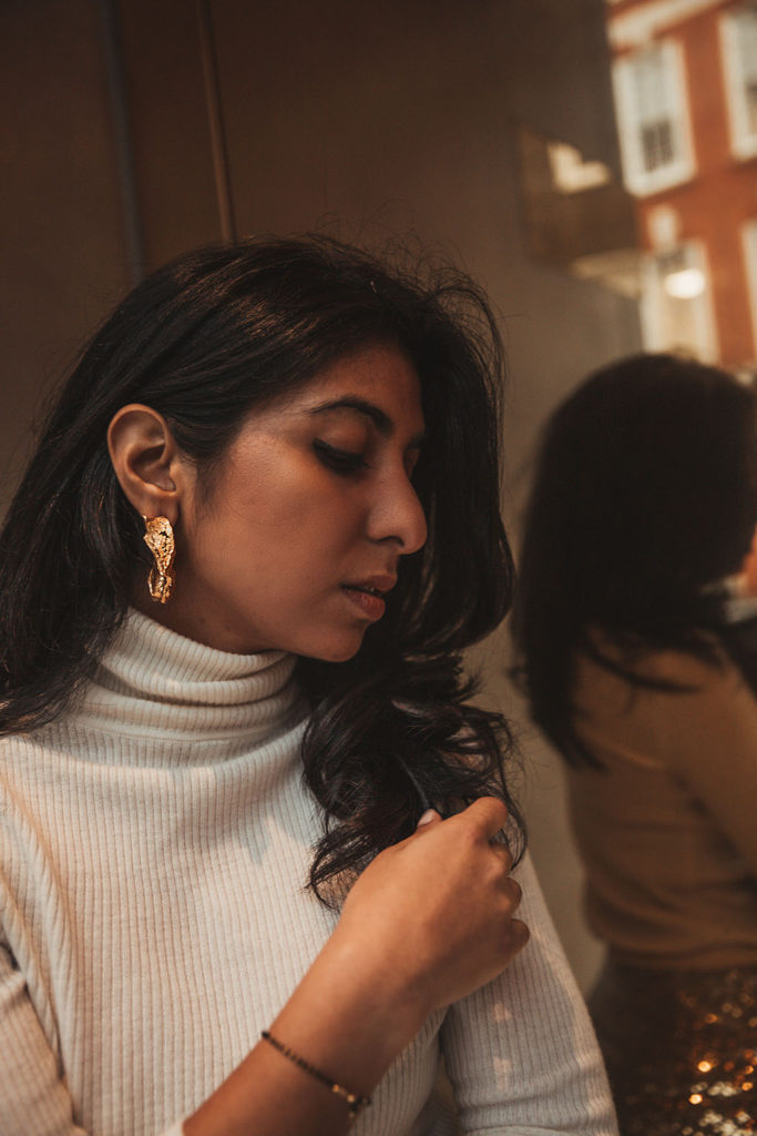 Luxury fashion blogger Shloka Narang of The Silk Sneaker shares a holiday party outfit idea featuring a sequins skirt from Topshop and Gianvitto Rossi heels