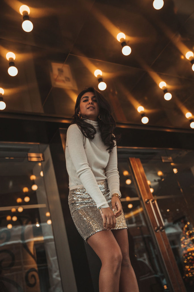 Luxury fashion blogger Shloka Narang of The Silk Sneaker shares a holiday party outfit idea featuring a sequins skirt from Topshop and Gianvitto Rossi heels