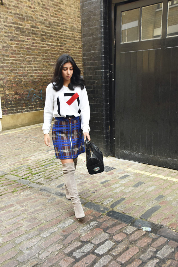 Fashion blogger Shloka Narang of The Silk Sneaker shows how to mix and match plaid in an Acne skirt and a Kenzo jumper