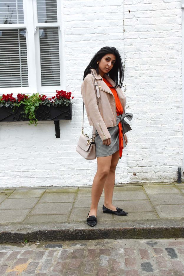 Fashion blogger Shloka Narang of The Silk Sneaker showcases how to combine spring colour combination pink and orange featuring Daniel Wellington