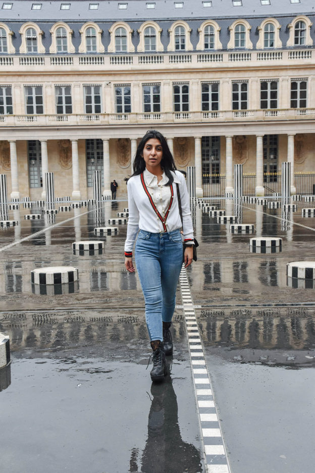 Fashion blogger Shloka Narang of The Silk Sneaker showcases a chic outfit in Paris featuring a Gucci Sweater