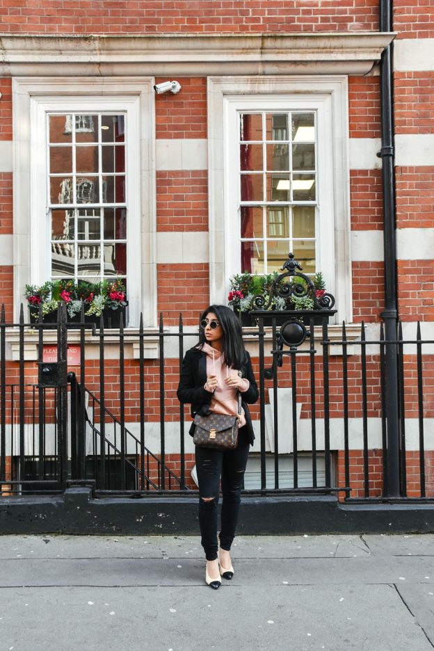 Fashion Blogger Shloka Narang of The Silk Sneaker showcases how to style a hoodie for everyday featuring Topshop hoodie and Frame Denim jeans