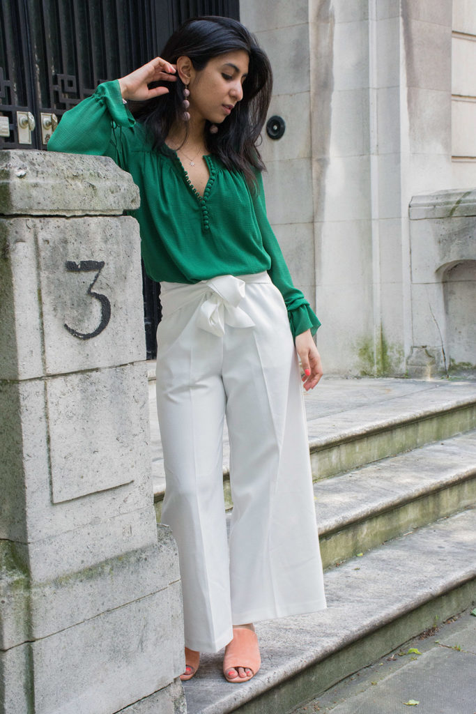 green top and white pants