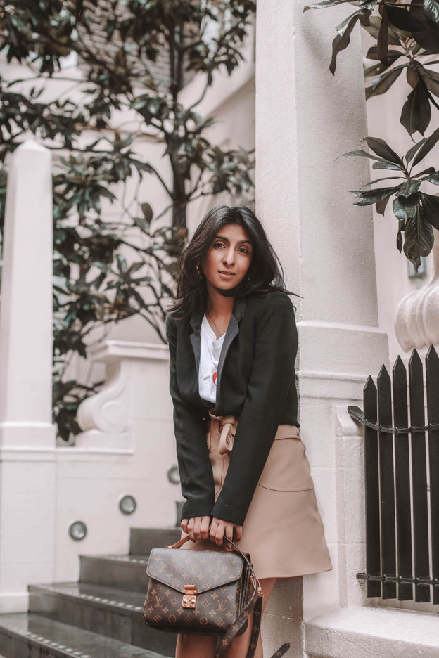 Fashion blogger Shloka Narang of The Silk Sneaker shares her style trick in how to style a blazer for a casual spring outfit idea featuring River Island, Maje, Louis Vuitton and Chanel