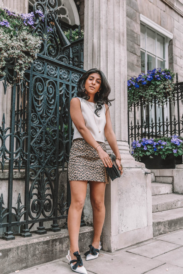 Fashion blogger Shloka Narang of The Silk Sneaker shares why you need a leopard print mini skirt in your wardrobe to create the perfect summer outfit featuring Topshop, Prada and Dior
