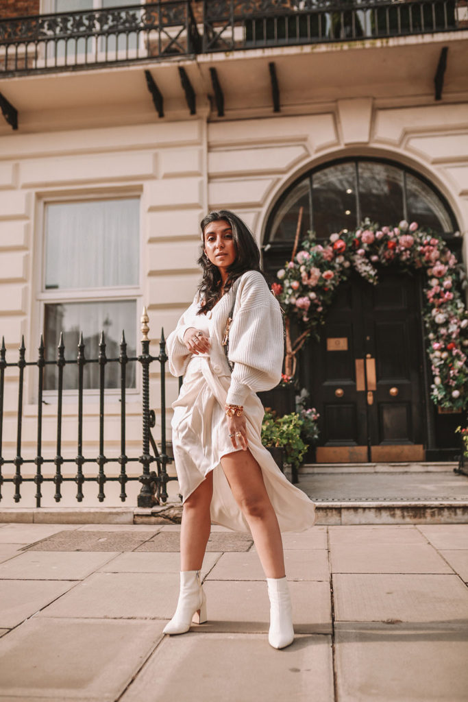 Luxury fashion blogger Shloka Narang of The Silk Sneaker shares how to create the perfect spring outfit to transition your wardrobe this March featuring a silk slip skirt, Dior Saddle bag and pearl hair clips
