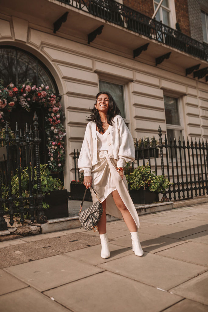 Luxury fashion blogger Shloka Narang of The Silk Sneaker shares how to create the perfect spring outfit to transition your wardrobe this March featuring a silk slip skirt, Dior Saddle bag and pearl hair clips