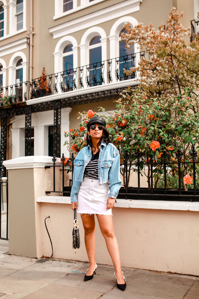 Luxury fashion blogger Shloka Narang of The Silk Sneaker shares how to wear a cropped denim jacket for the perfect summer outfit featuring Topshop, Dior and Claudie Pierlot