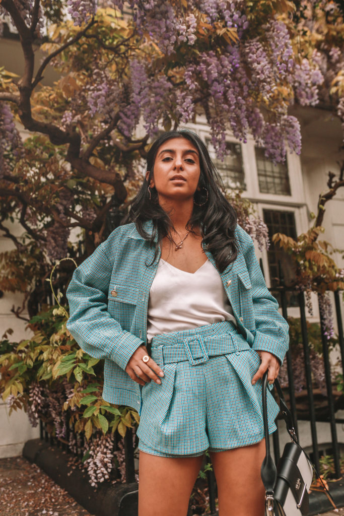 Luxury fashion blogger Shloka Narang of The Silk Sneaker shows how to style matching sets in a Maje coord suit, Prada bag and Valentino Sandals in London with Wysteria