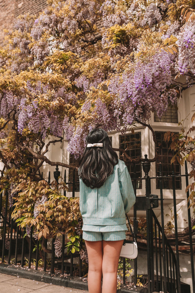 Luxury fashion blogger Shloka Narang of The Silk Sneaker shows how to style matching sets in a Maje coord suit, Prada bag and Valentino Sandals in London with Wysteria
