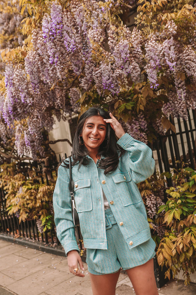 Luxury fashion blogger Shloka Narang of The Silk Sneaker shows how to style matching sets in a Maje coord suit, Prada bag and Valentino Sandals in London with Wysteria