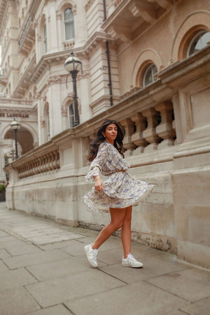 Luxury fashion blogger Shloka Narang of The Silk Sneaker shares how to pair a midi summer dress with sneakers for a casual summer outfit featuring a floral dress from & Other Stories and Veja sneakers