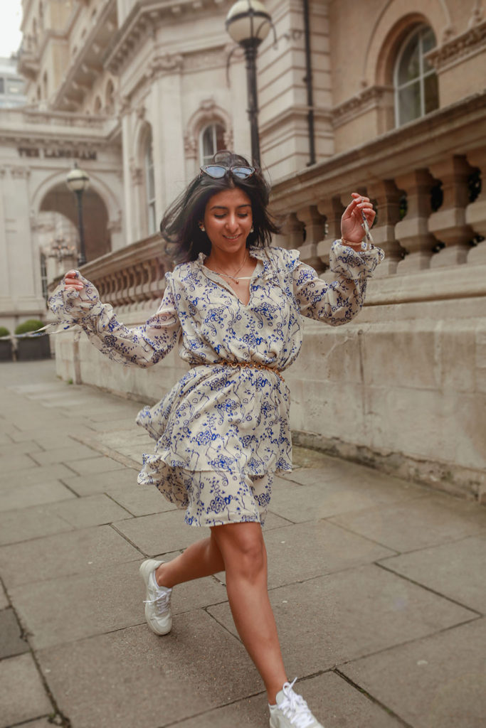 Luxury fashion blogger Shloka Narang of The Silk Sneaker shares how to pair a midi summer dress with sneakers for a casual summer outfit featuring a floral dress from & Other Stories and Veja sneakers